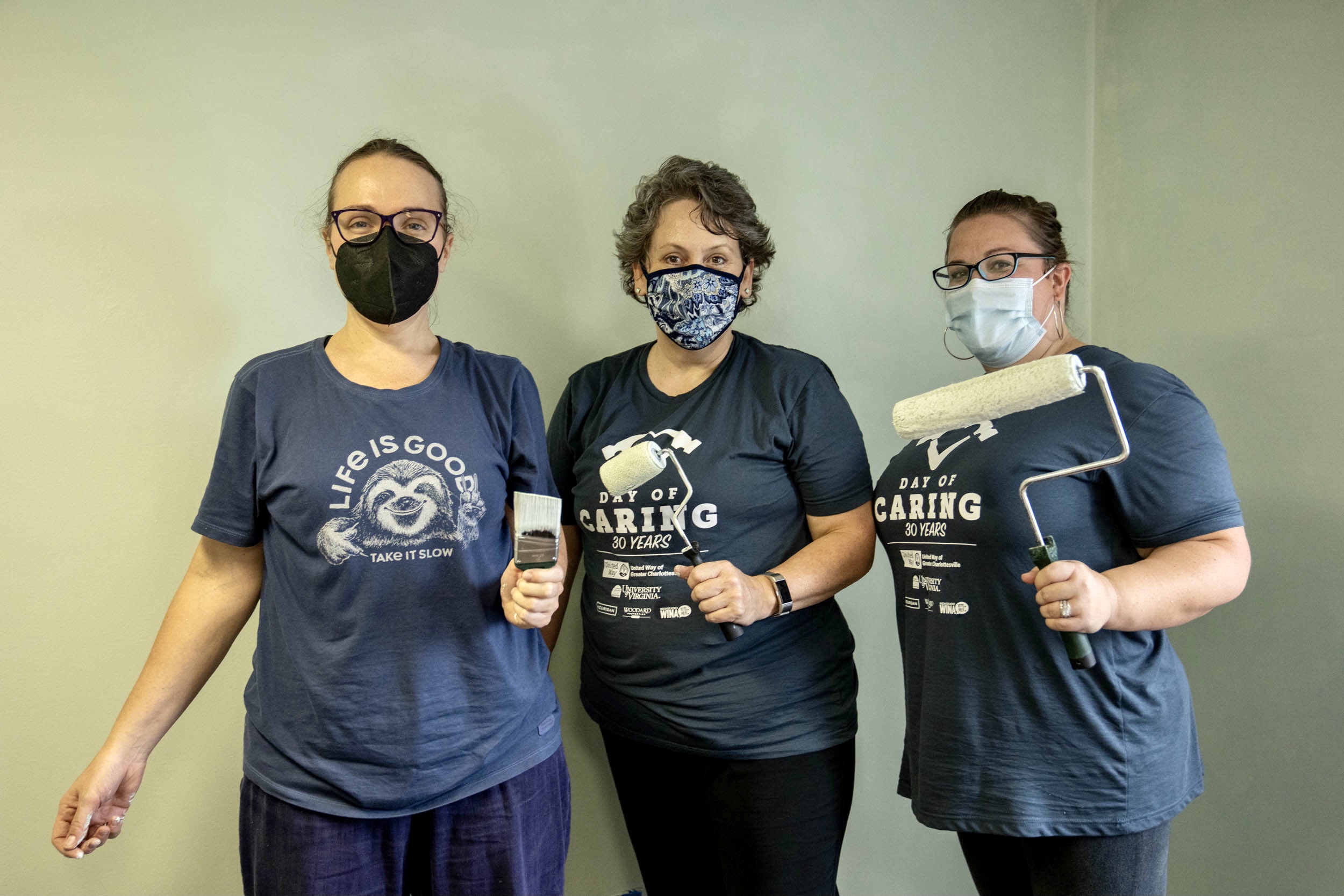 3 staff members from O'Neil Hall stand ready to paint at Piedmont CASA for Day of Caring on 9/22/21