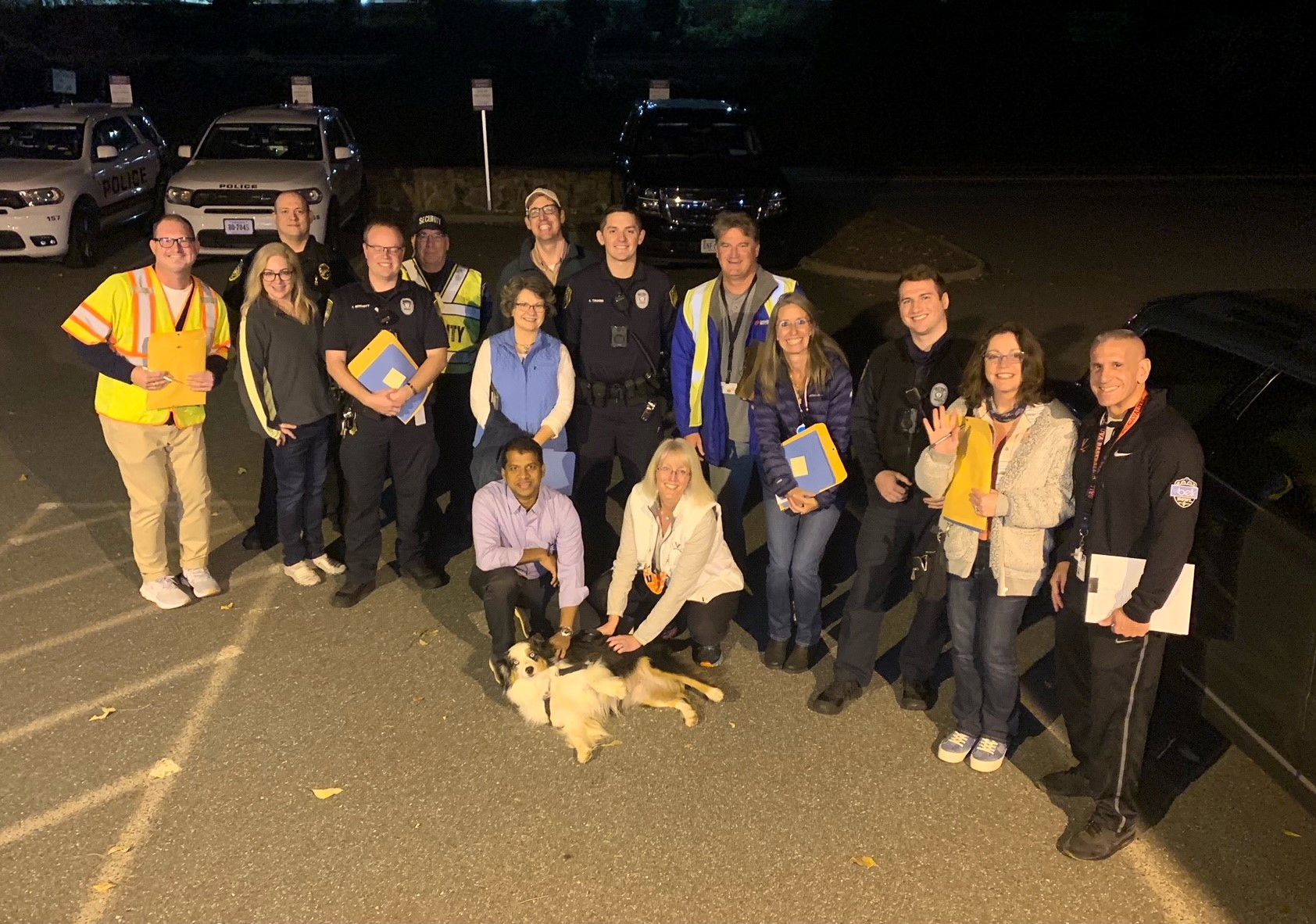 Staff from the Department of Safety and Security, inclding K-9 Cooper, gather for a safety night walk with faculty and staff colleagues