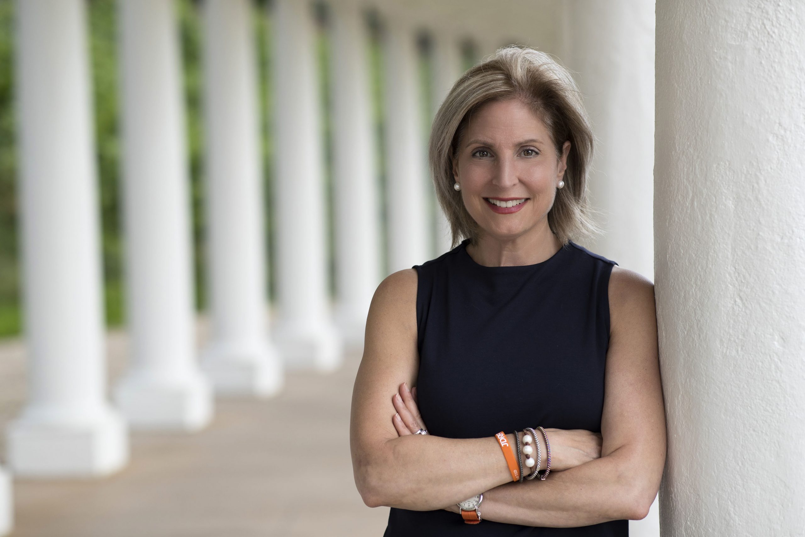 Alice Raucher standing on colonnade with arms folded