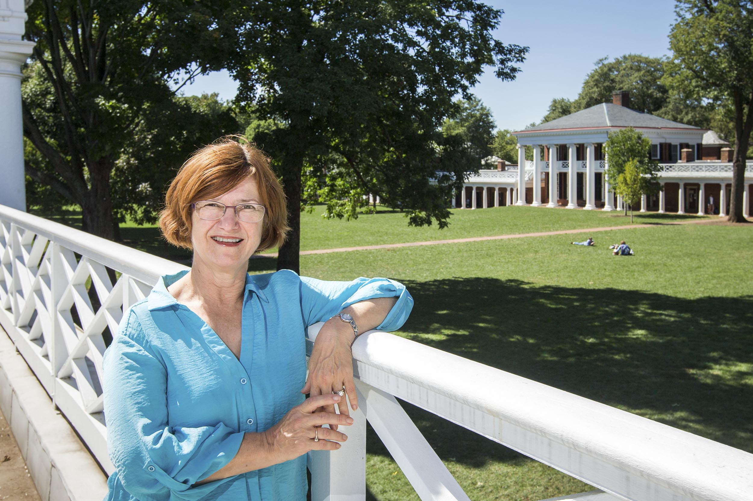 Mary Hughes leans on a railing overlooking the Lawn