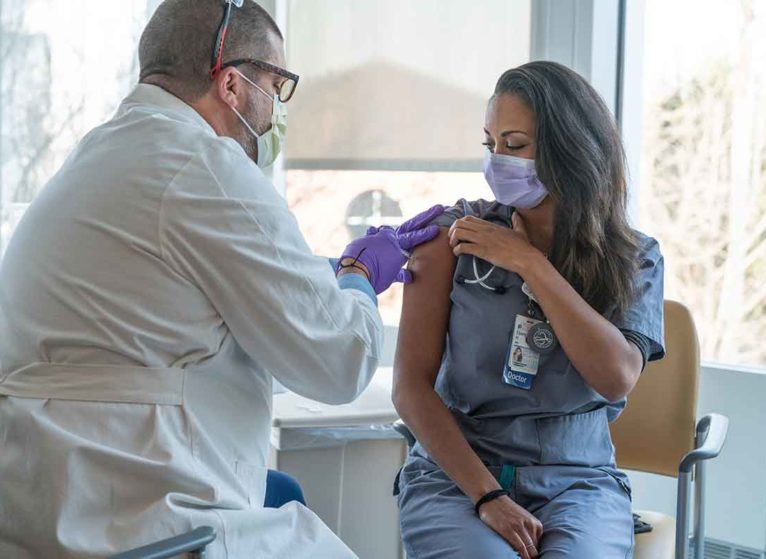 A doctor receiving a COVID-19 vaccination at UVA Health