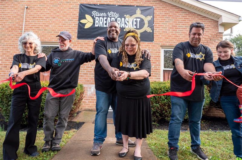  Facilities Management meter technician A.J. Young, center, and his wife Adrienne celebrate the opening of a food pantry in Waynesboro. (Photo courtesy A.J. Young)