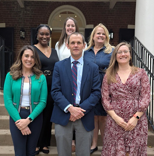 UVA Pres Jim Ryan standing on steps with HR Career Navigation Team