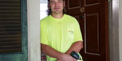 Carpenter Andrew Shelton stands in the doorway of Lawn Room 43