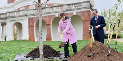 Colette Sheehy shoveling dirt with President Jim Ryan on the East Rotunda while planting a tree