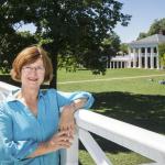 Mary Hughes leans on a railing overlooking the Lawn